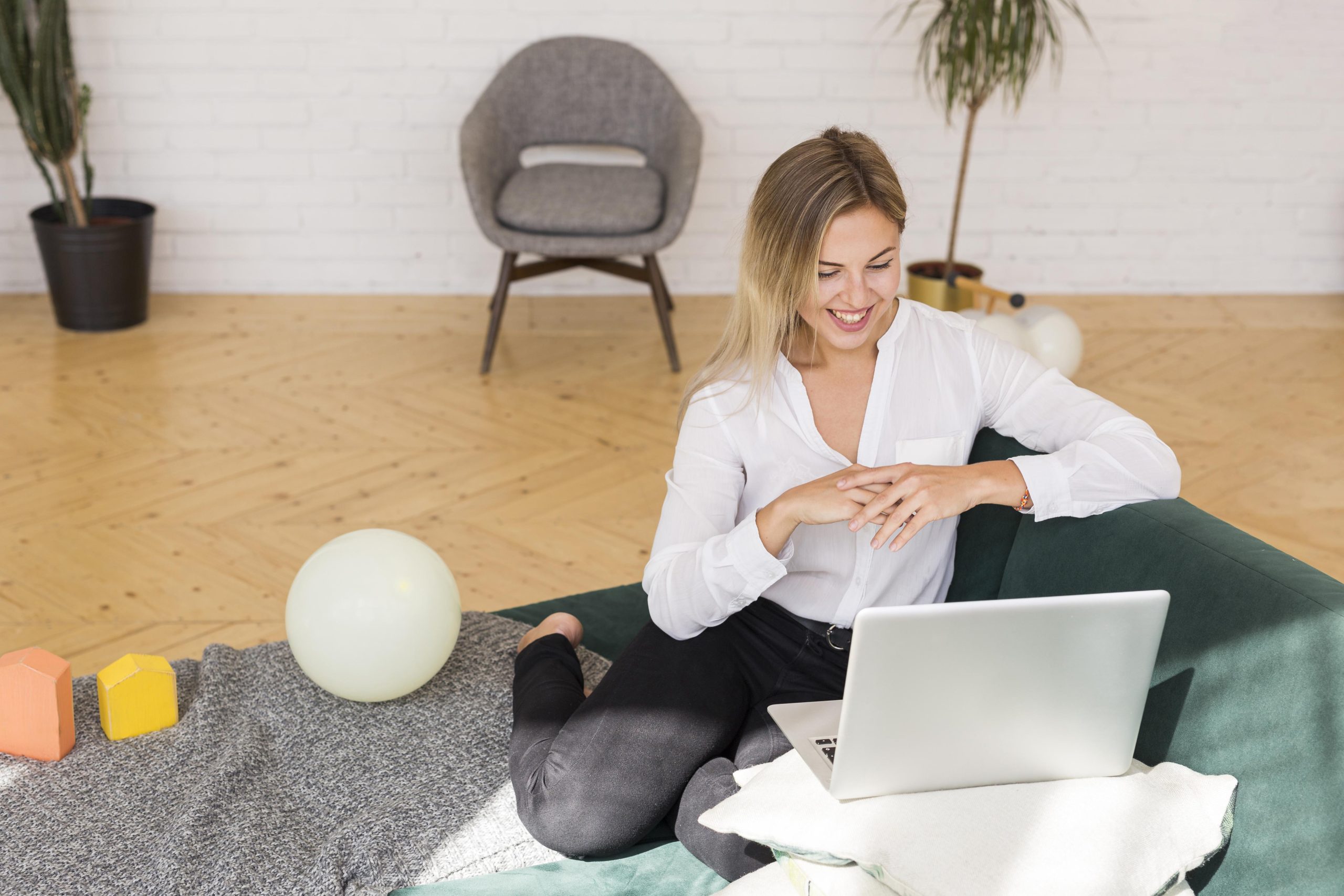 full shot smiley woman couch working scaled